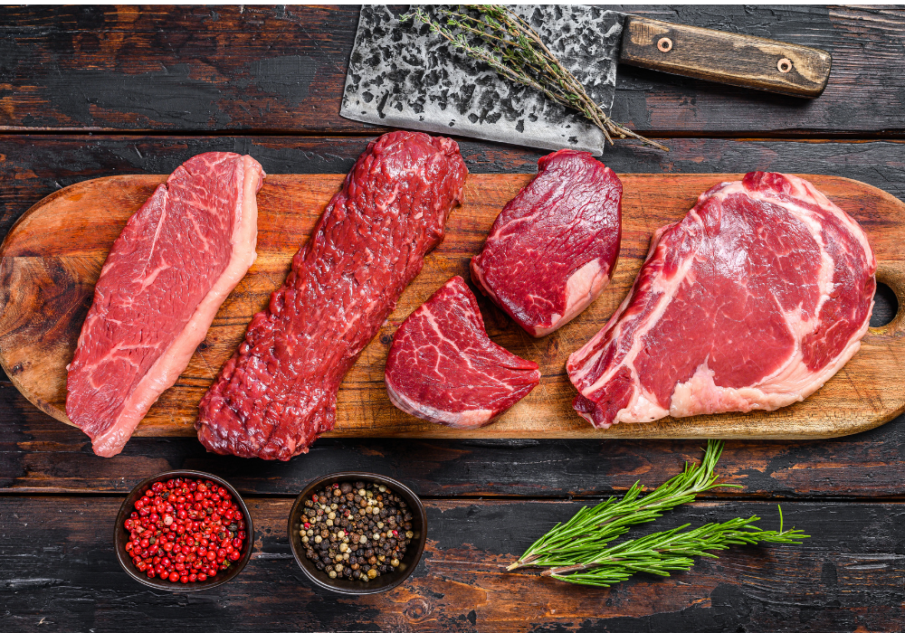 A selection of beef cuts on a wooden cutting board